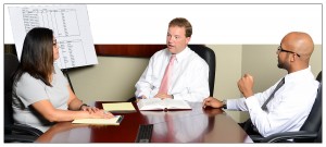 three professionals at conference table